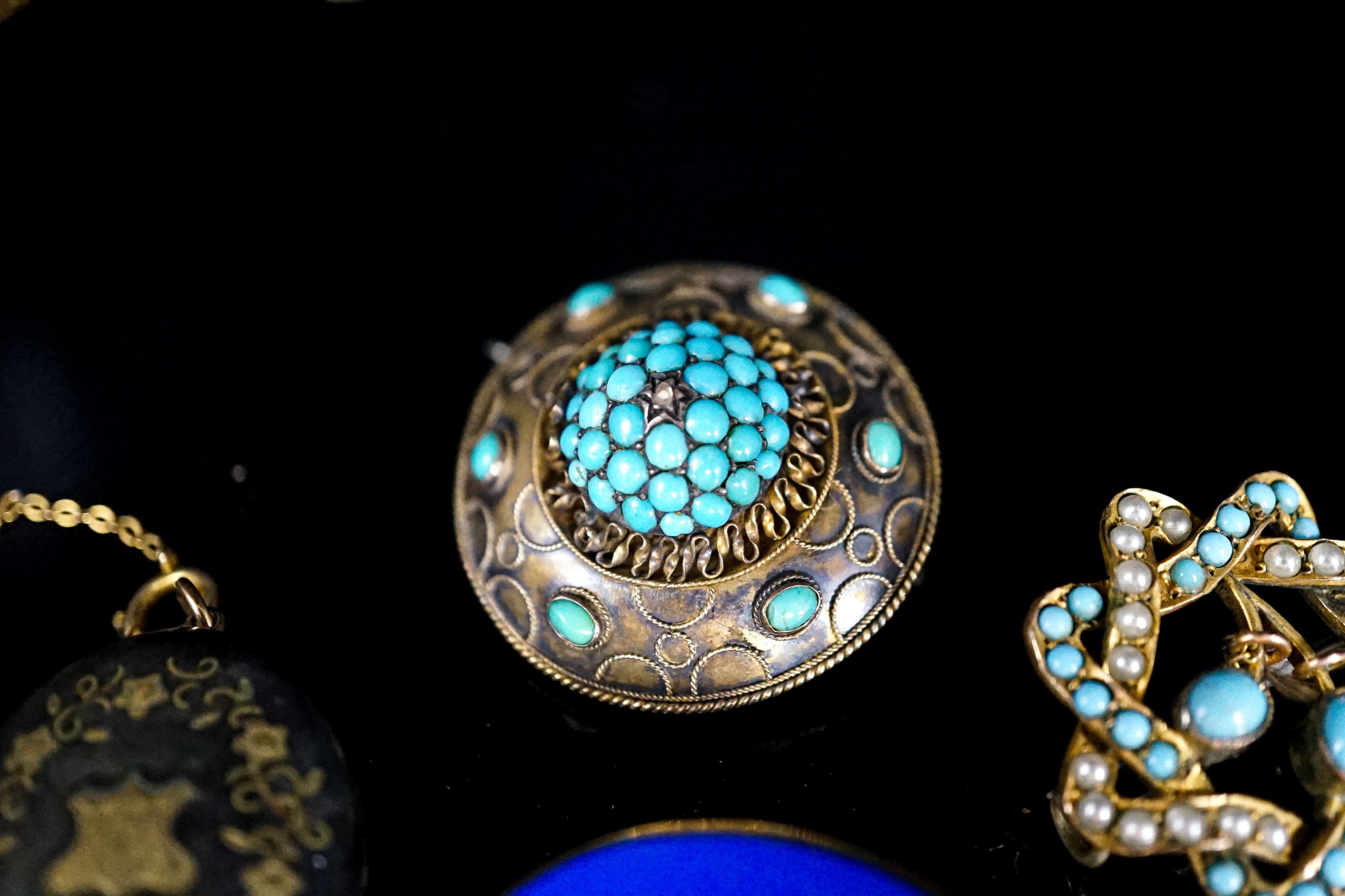 A yellow metal mounted micro mosaic oval brooch, 32mm, a Victorian mourning brooch, one other turquoise and split pearl brooch and a tortoiseshell pique locket on chain.